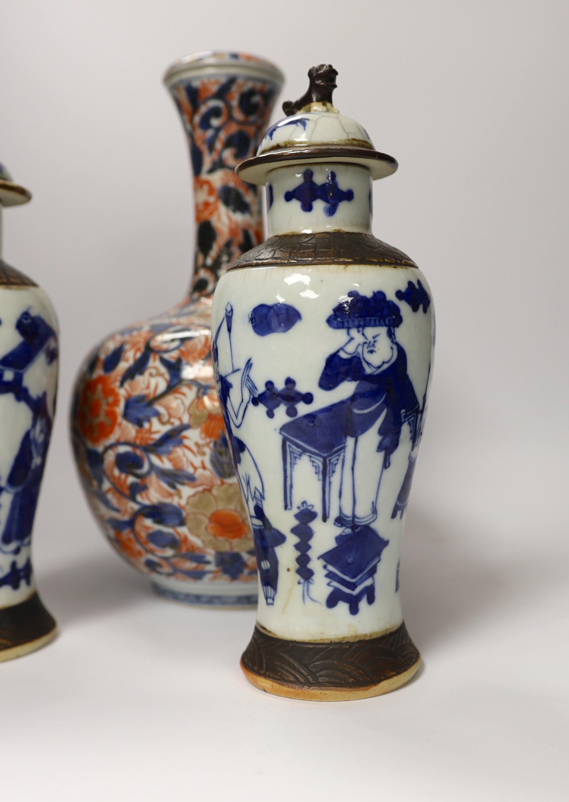 A pair of Chinese blue and white crackleware vases and covers and an Imari vase and cover, largest 31cm high